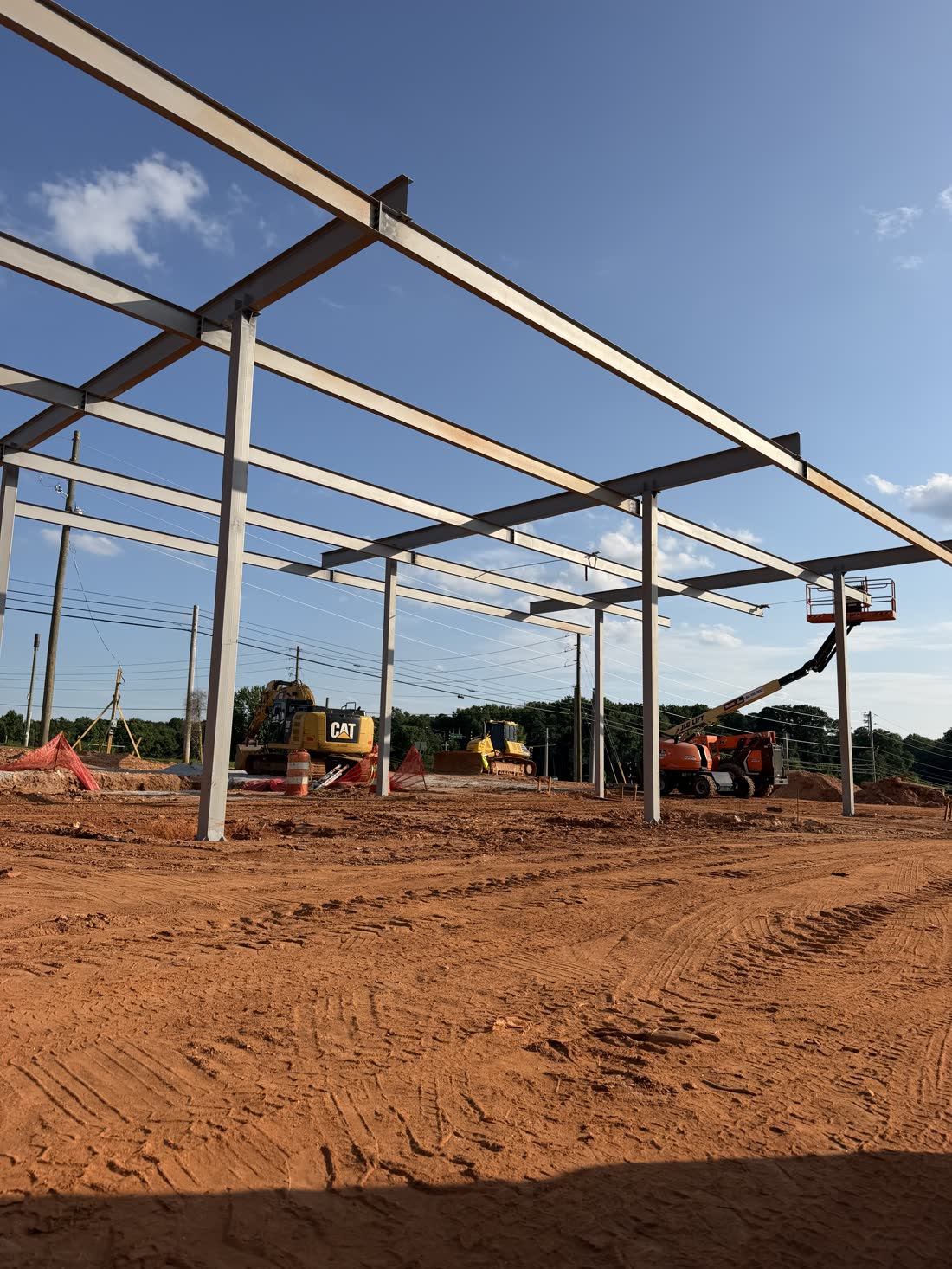 A run of steel canopy columns and beams part way through erection