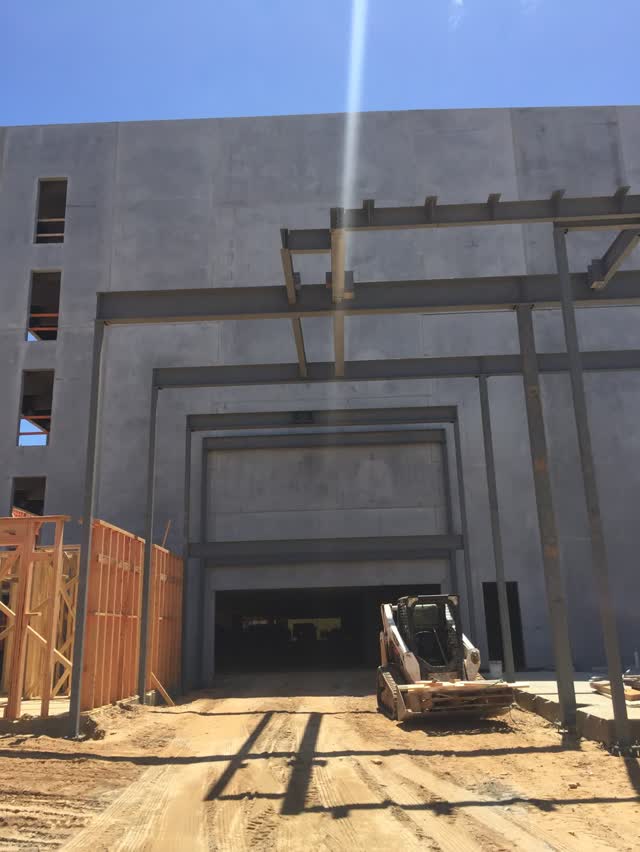 Steel frame erected at a concrete loading dock opening
