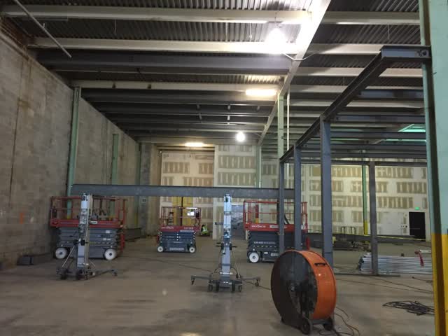 Interior structural steel frame and roof framing inside a large building shell