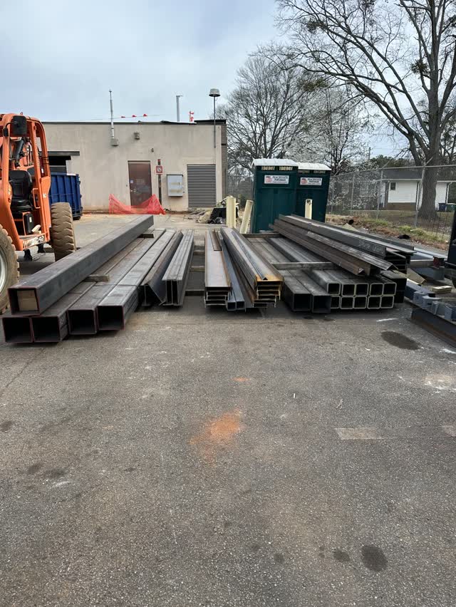 Fabricated steel members laid out on the ground after delivery to a jobsite