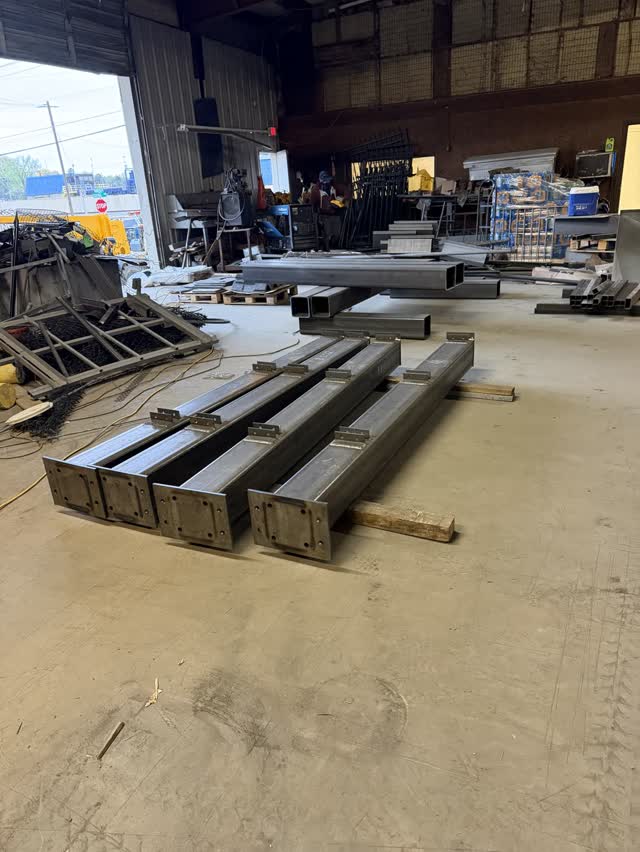 Steel material staged on the floor of the fabrication shop