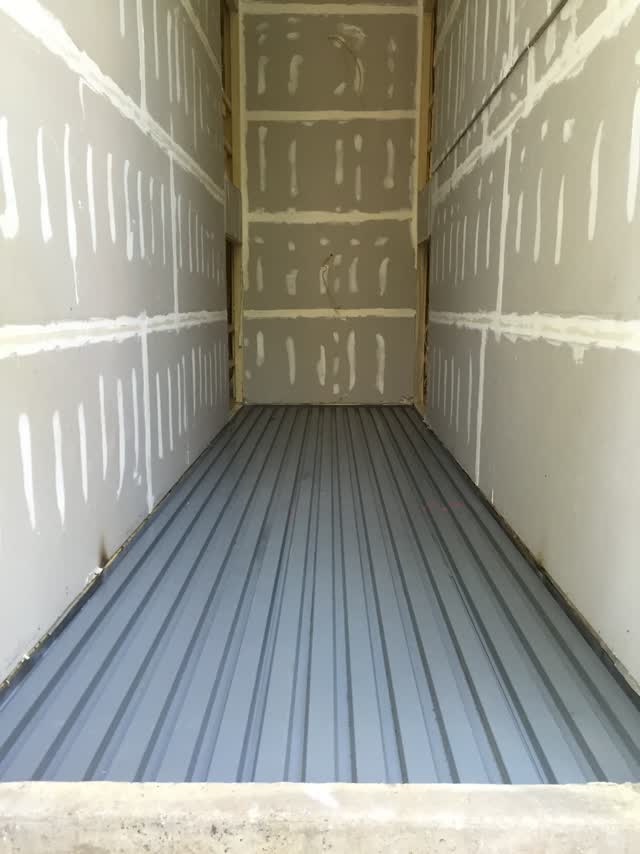 Metal deck and steel framing forming the ceiling of a breezeway