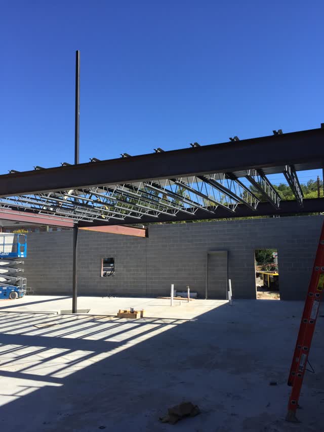Open-web steel joists and roof framing in place on a building