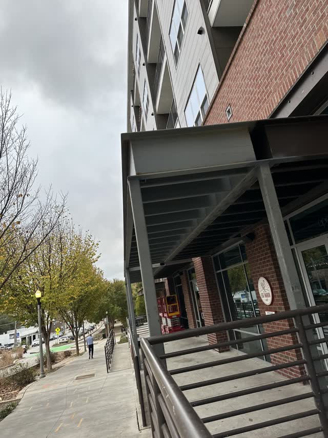 Completed steel storefront canopy along a retail frontage