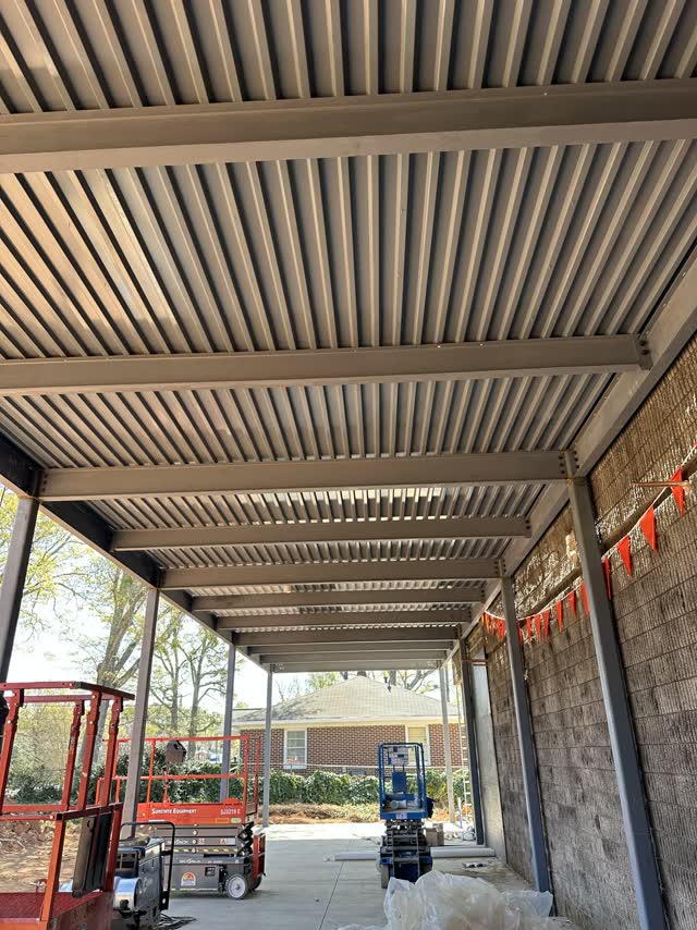 Finished louvered steel canopy seen from below