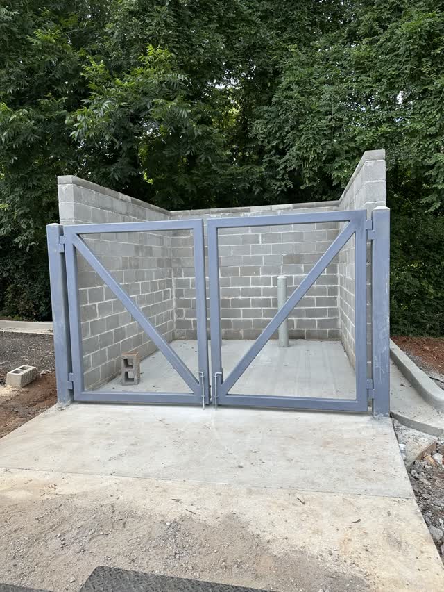 Galvanized steel gate frame set at a masonry enclosure