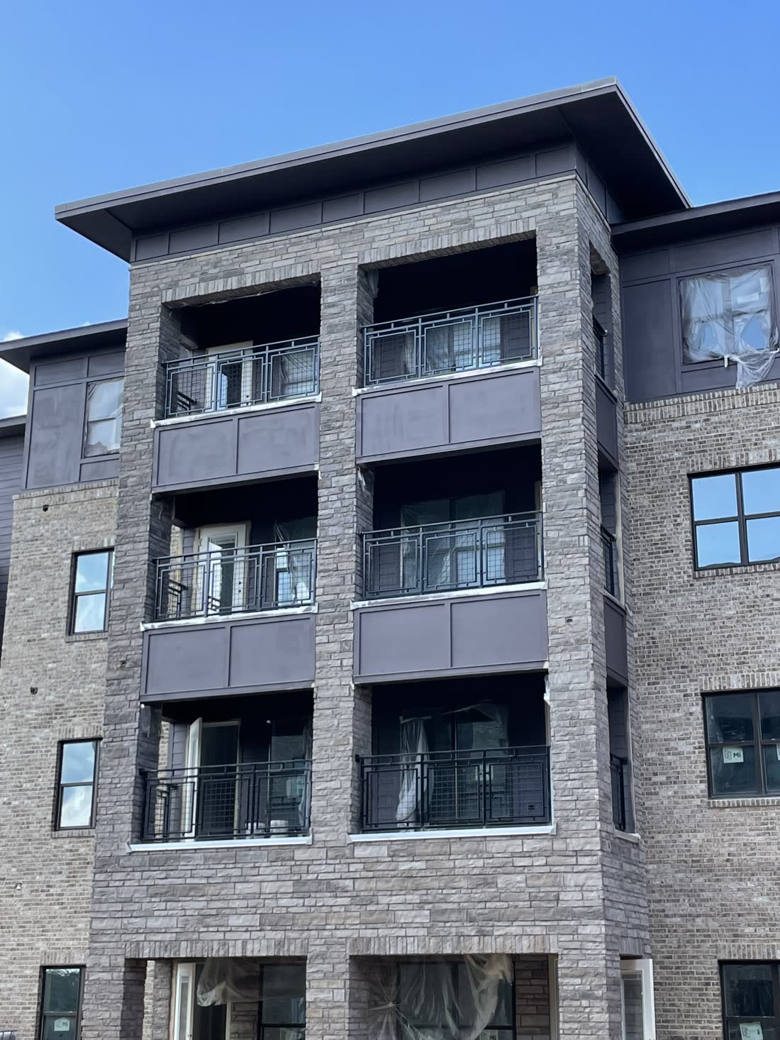 Apartment building with steel balcony framing and guardrail