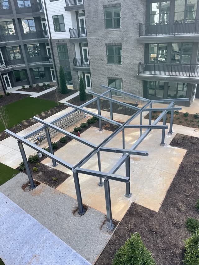 Steel courtyard pergolas installed between apartment buildings