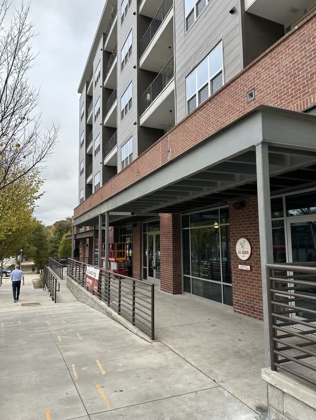 Steel canopy and frame at the ground floor retail level of a mixed-use building