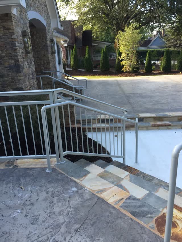 Steel handrail installed at exterior stone steps