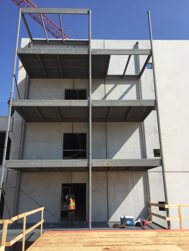 Multi-story exterior steel stair tower on a concrete building